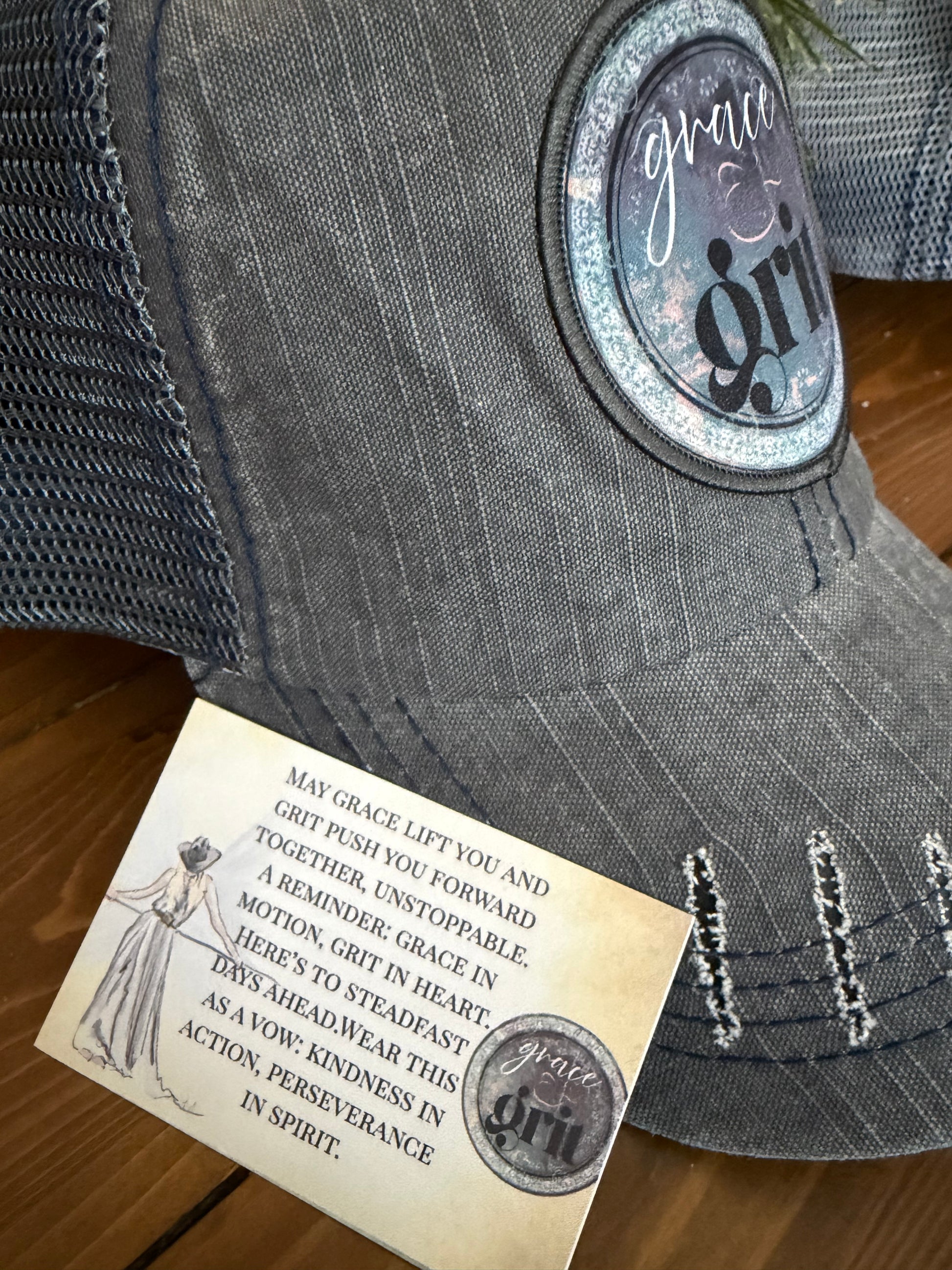 Gray fabric with a brand label and a vintage-style card on a wooden surface