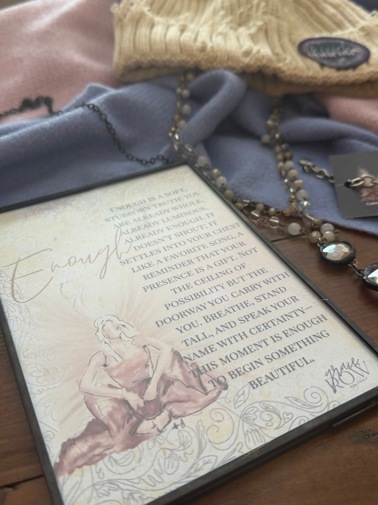 Necklace with a pendant on an open book with text and illustrations.