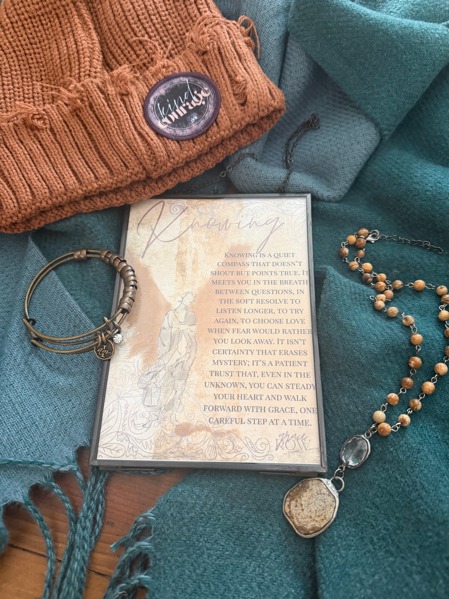 Art Print  with text, a rosary bead necklace and a bracelet on a textured blue surface