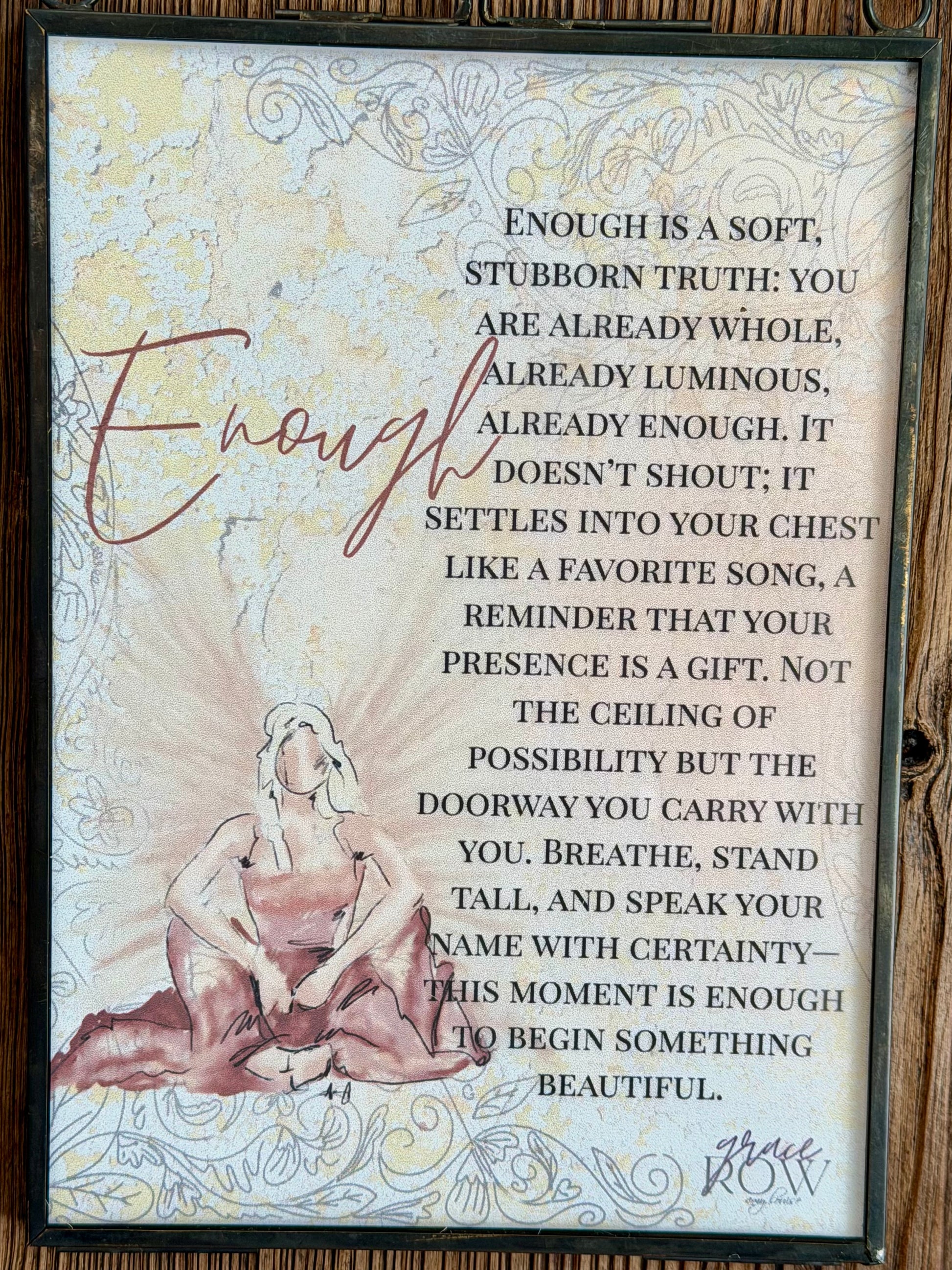 Decorative wall art with a quote and a woman's silhouette on a wooden background