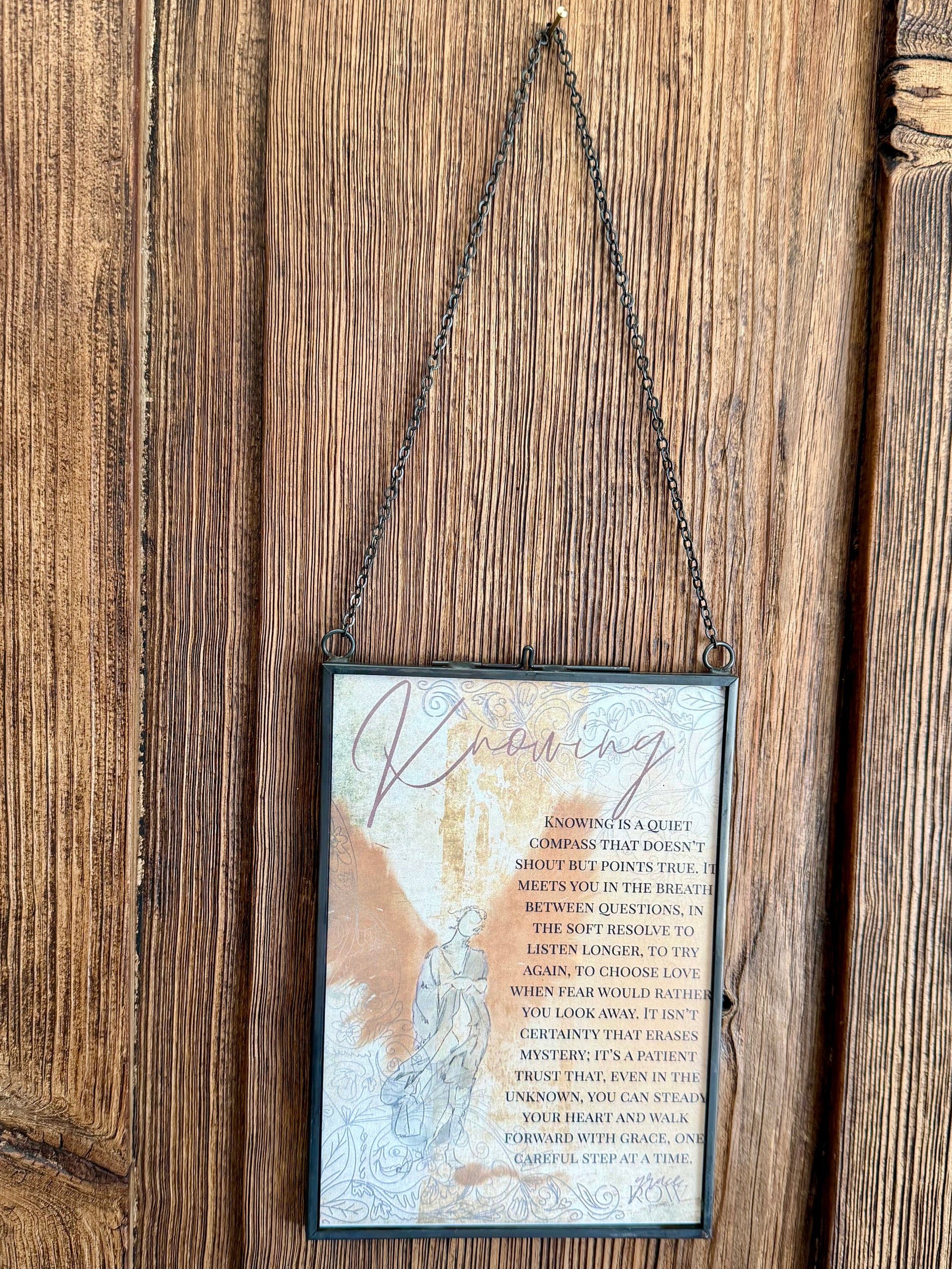 Decorative sign with text and map design hanging on a wooden wall.