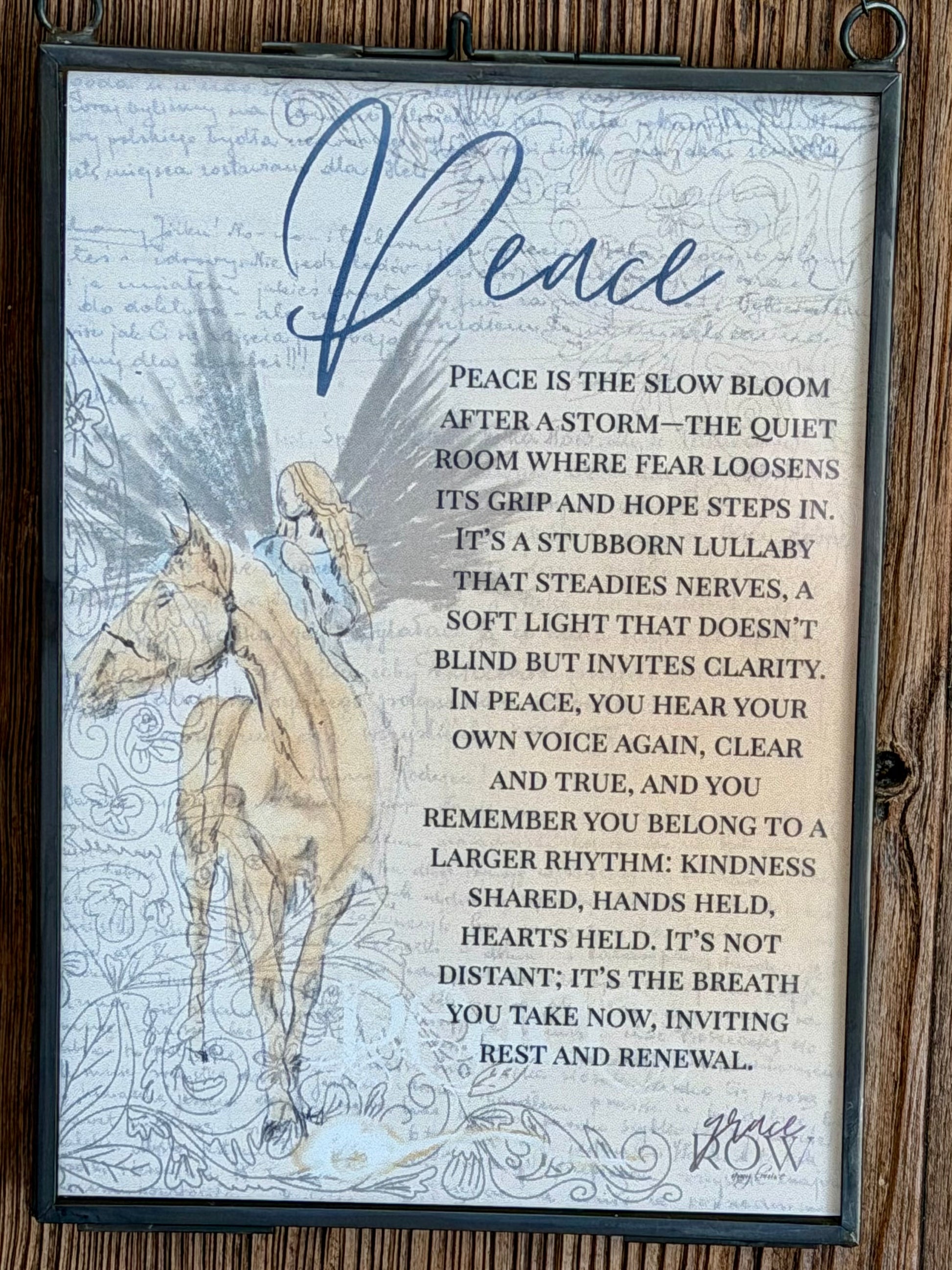 Decorative sign with horse illustration and 'Peace' text on a wooden background