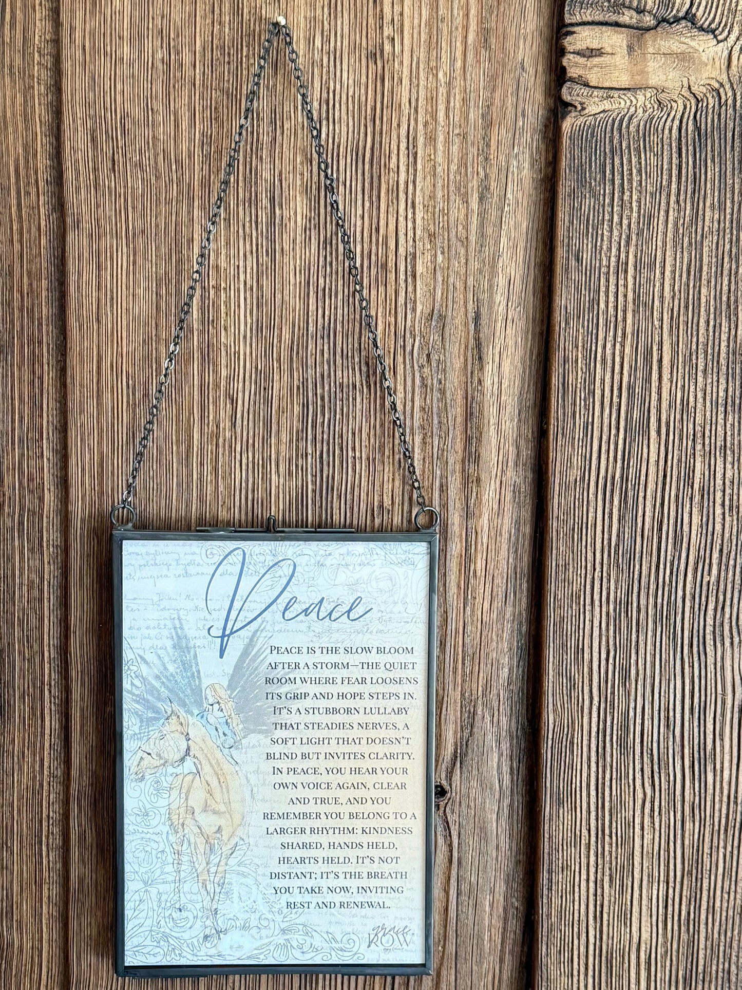 Decorative sign with text and a horse illustration hanging on a wooden door.