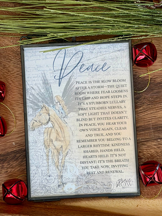 Decorative card with horse illustration and text on a wooden surface with red jingle bells.