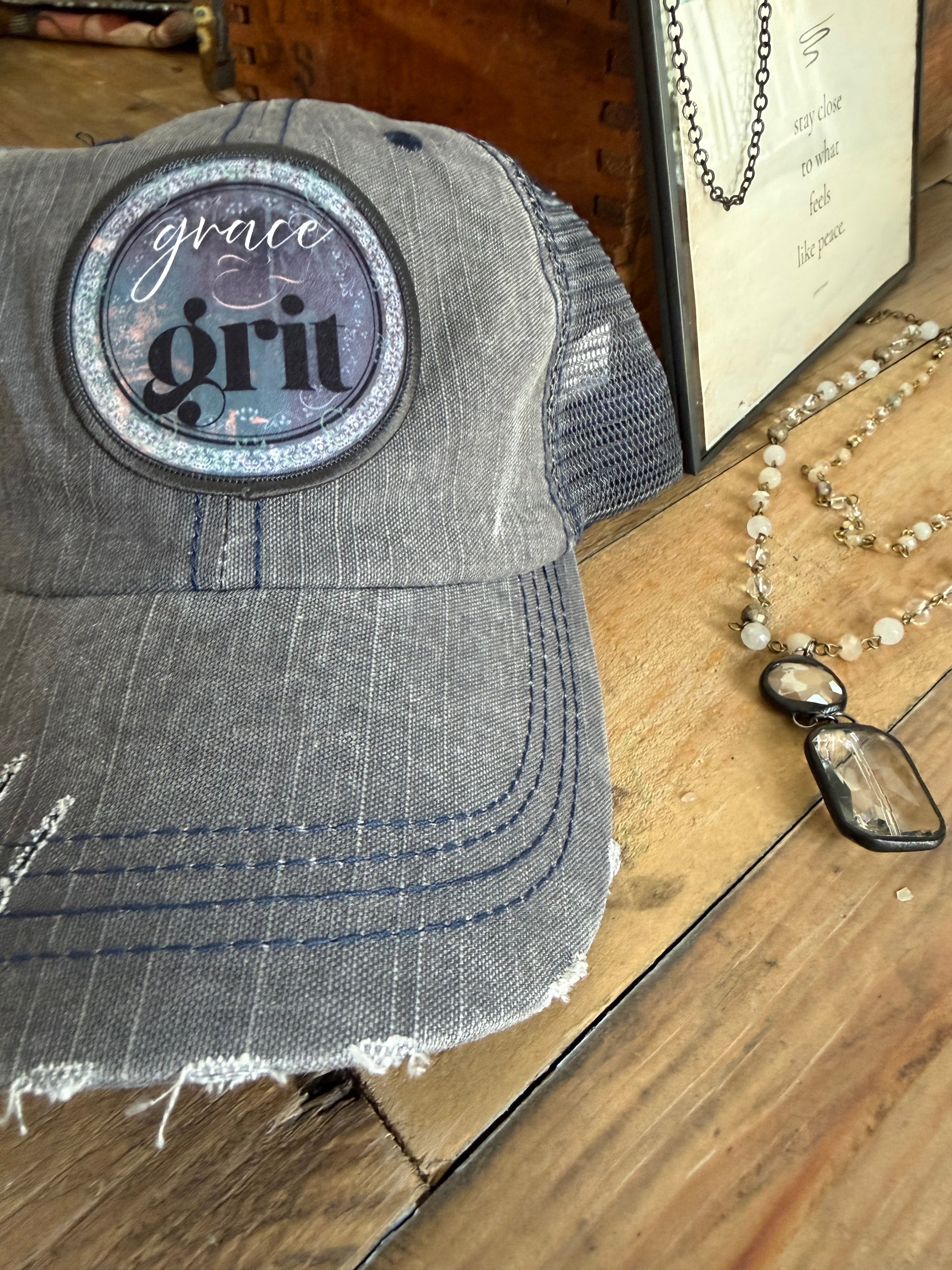 Gray denim patch with 'Grunt Style' logo on a wooden surface