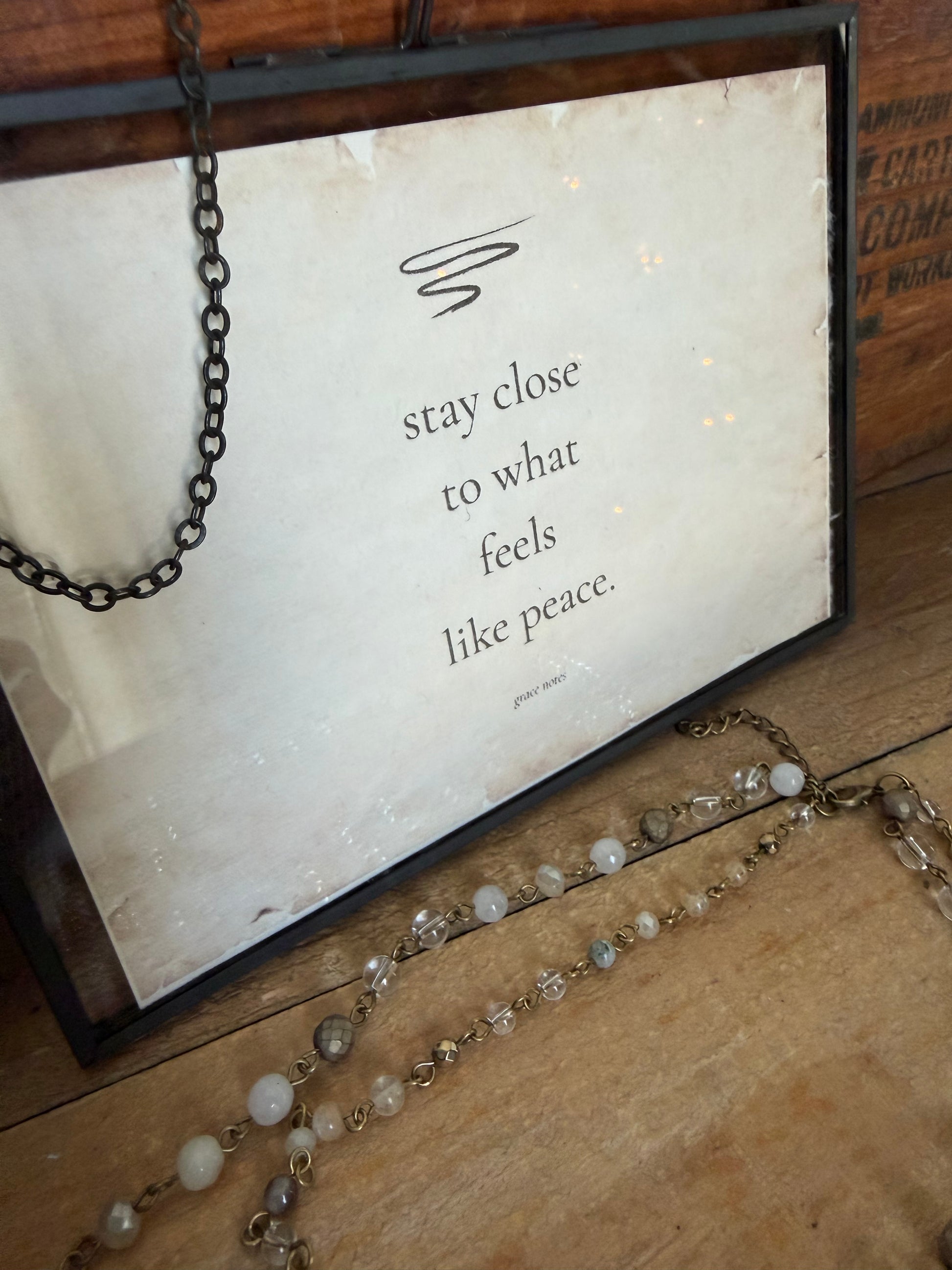 Necklace with a quote card on a wooden surface