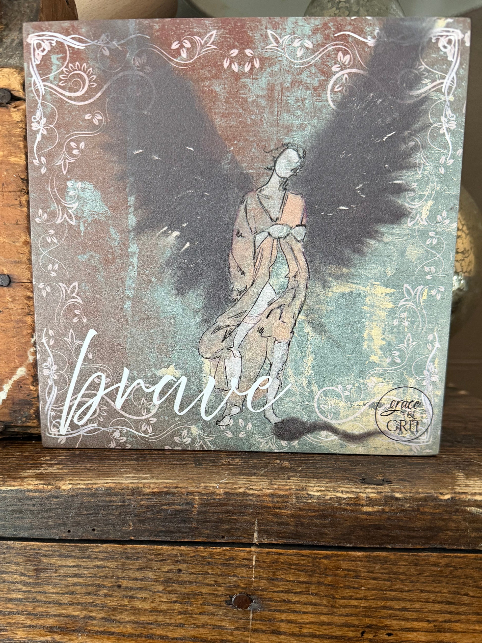 Decorative book with a hand holding a heart design on a wooden surface