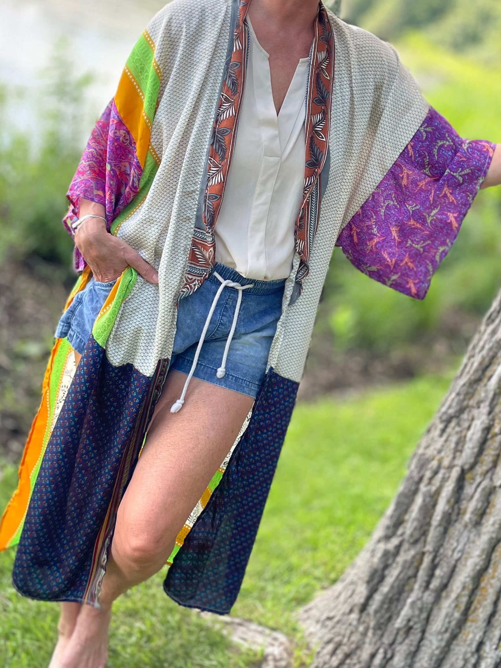 Woman leaning against a tree in a natural setting
